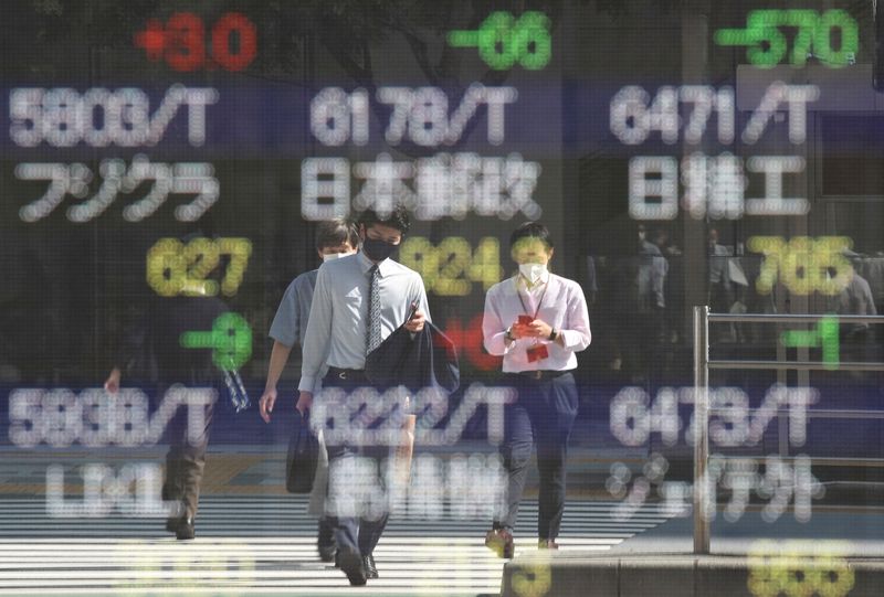 Asian stocks dip as Omicron spreads, Fed decision looms