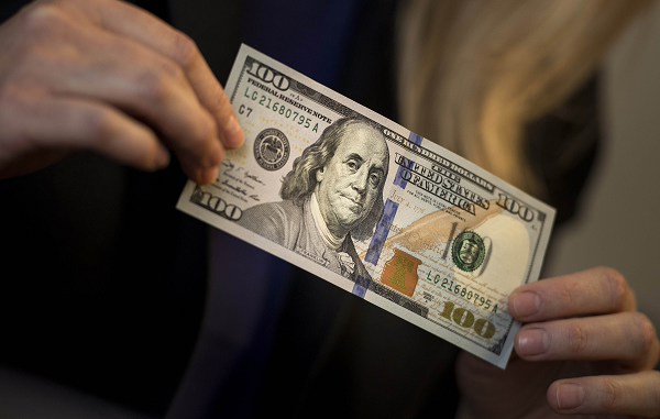 Dollar gets a lift from upbeat Fed report