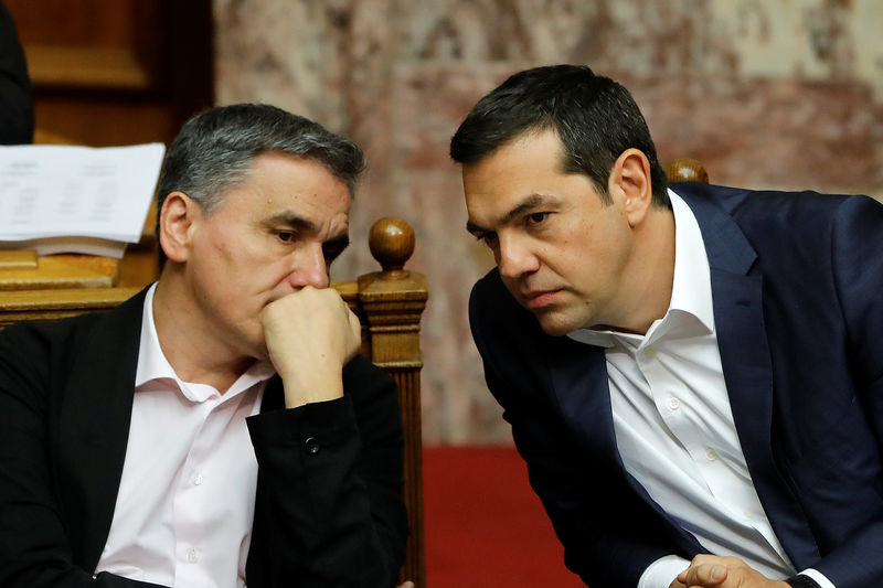 Greece passes fast-track reform package to unlock bailout cash