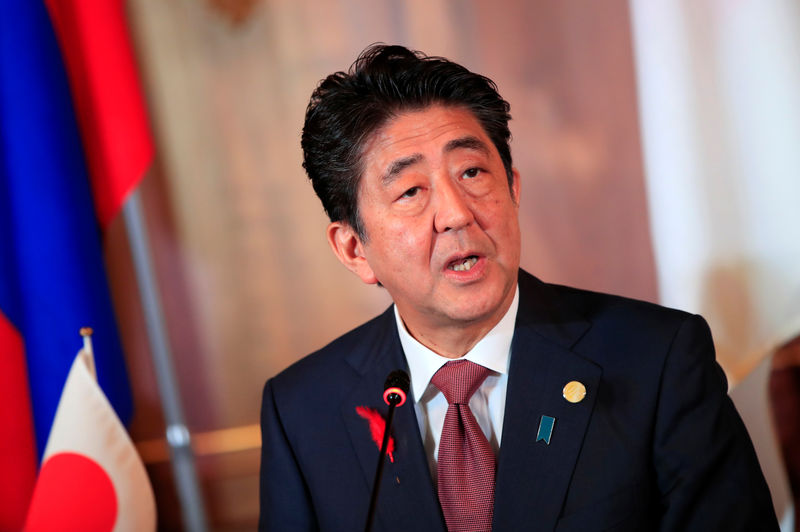 Japan PM Abe pledges to go ahead with sales tax hike next year