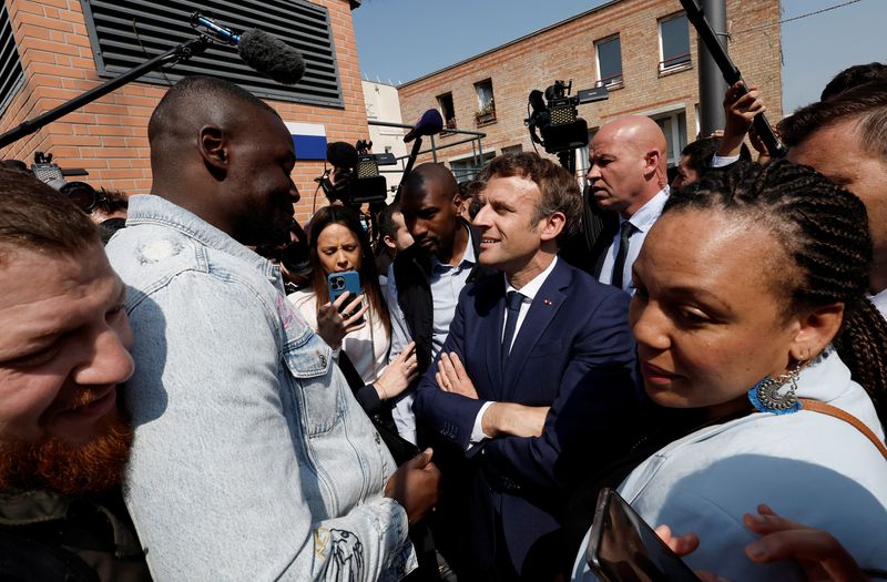 Macron, with eye on parliamentary vote, visits left-leaning Paris suburb