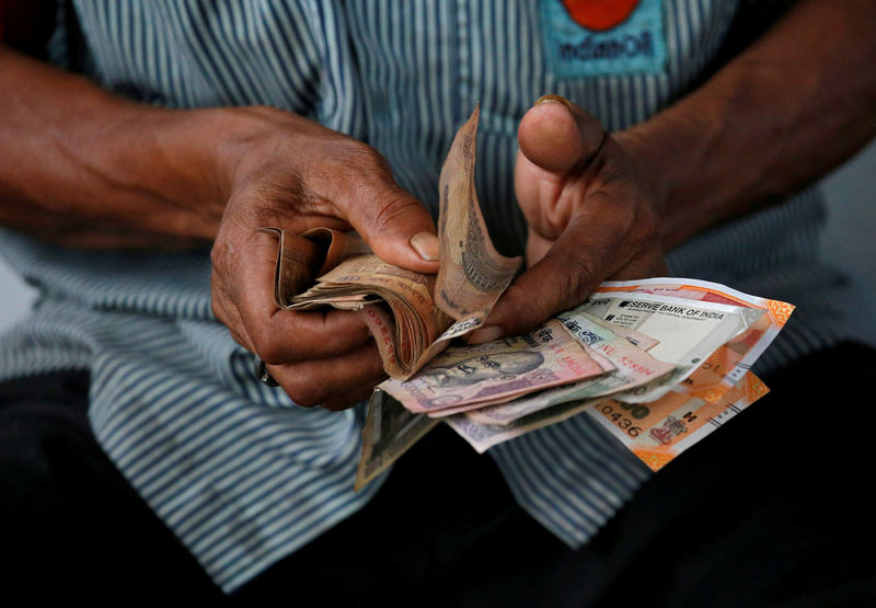 With an eye on faltering rupee, RBI to raise rates next week: Reuters poll